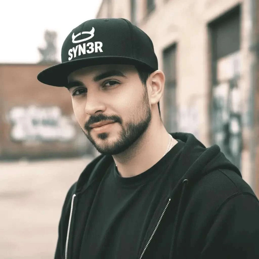 Black SYN3R Snapback Cap, close-up on model